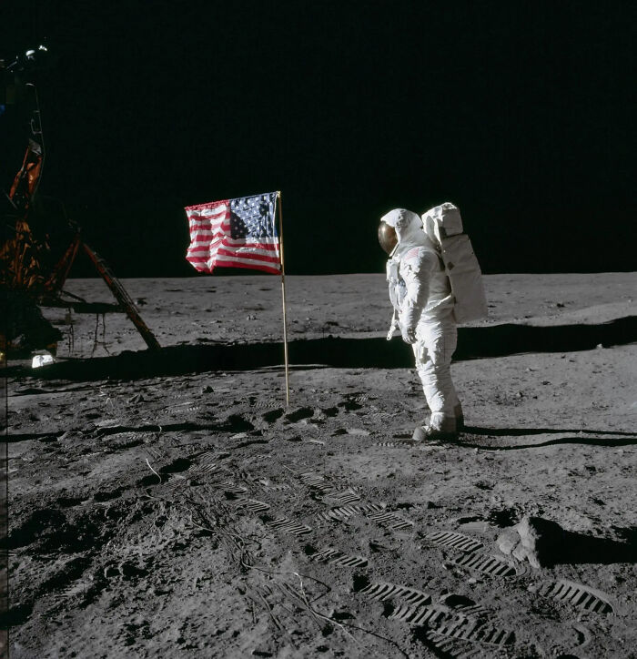 Astronaut on the Moon next to the American flag, representing major historical events from the year you were born.