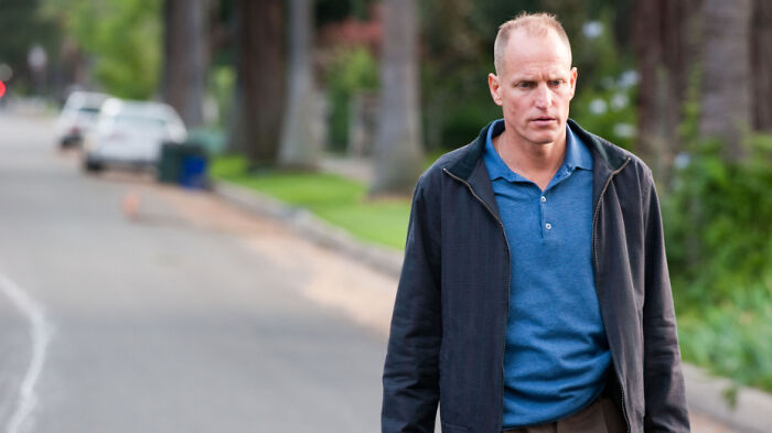 Man walking alone on a suburban street, looking concerned, illustrating PR mistakes that companies did not expect to backfire.
