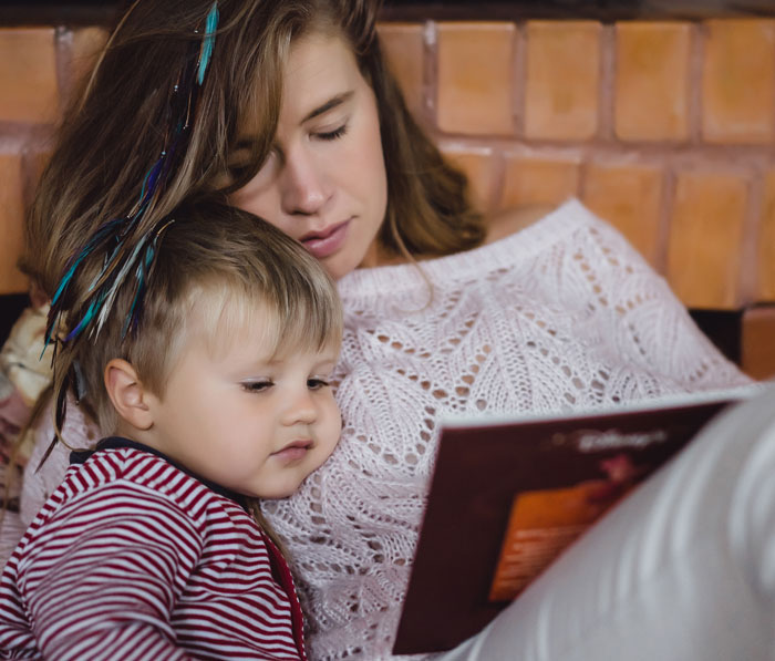 Mom and child reading together, highlighting family moments amid complex parent-child relationships and parenting challenges.