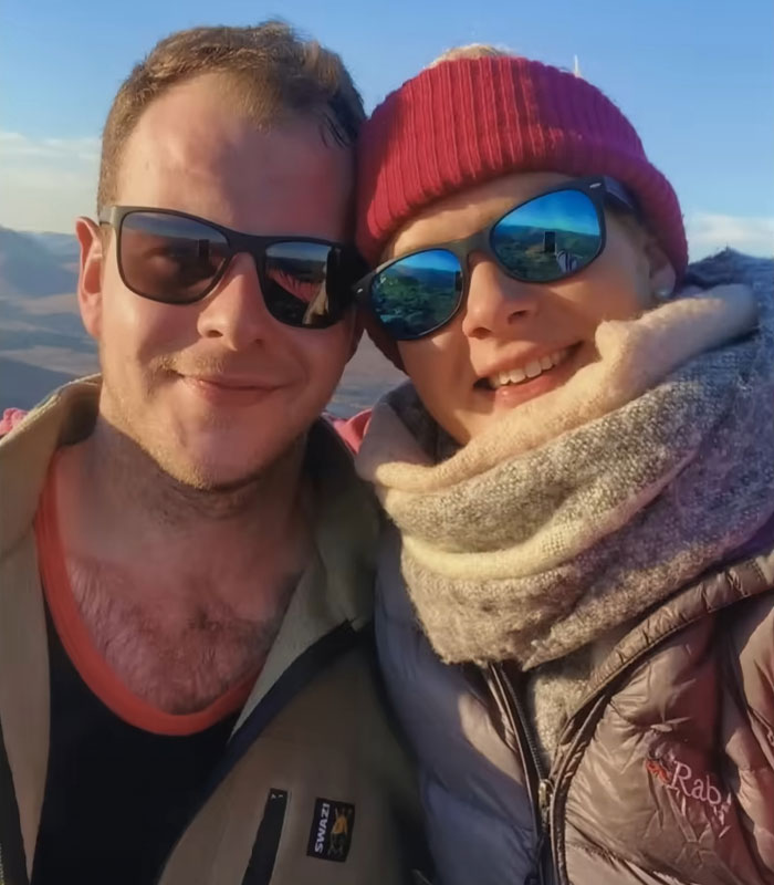 Couple wearing sunglasses outdoors with mountains in the background, highlighting devastated bride-to-be and fianc&eacute; crimes.