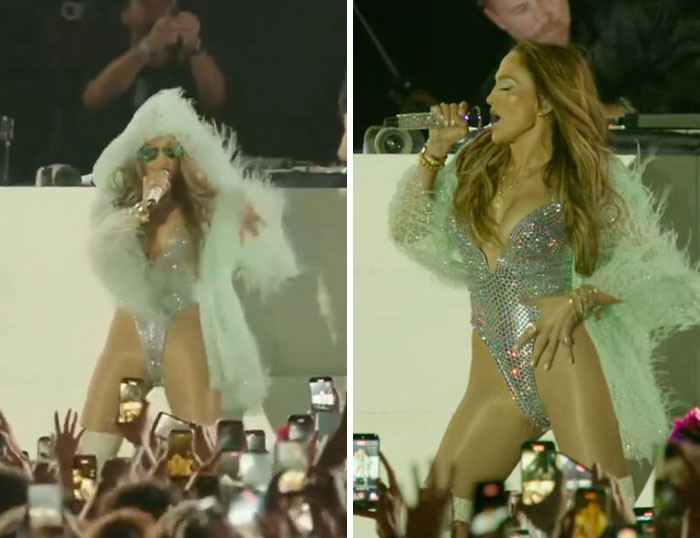Female performer in sparkling outfit and feathered coat singing energetically at Coachella 2026 festival with crowd filming.
