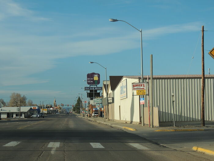 Empty street in a small US town showing some rundown shops and buildings among the worst places in the US.