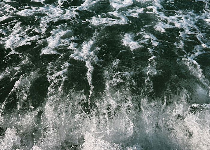 Rough ocean water with waves and foam, illustrating dangers in nature that are more serious than they appear.