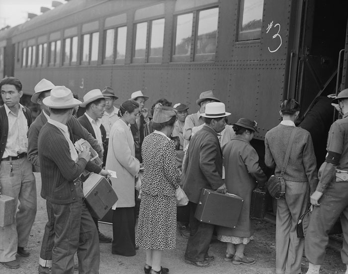 People boarding a train during a historic moment reflecting massive betrayals in human history still discussed today.