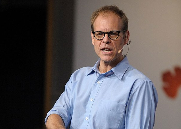 Man wearing glasses and a blue shirt speaking with a headset microphone about beloved celebrities not that nice in real life.
