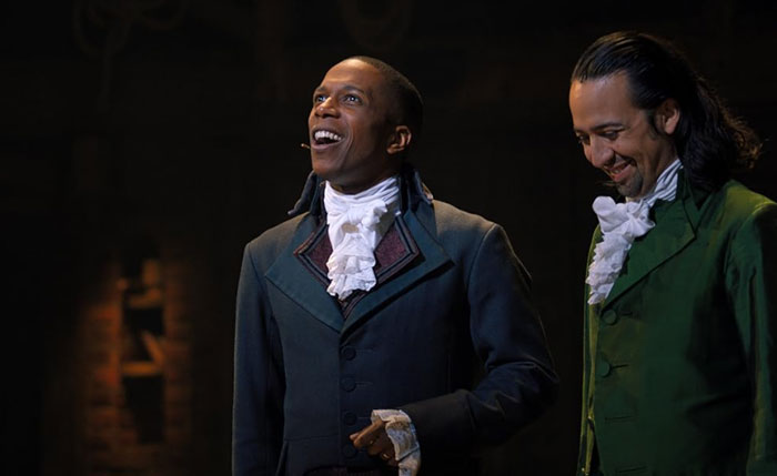 Two actors in period costumes performing on stage, illustrating moments of oversleeping turning into a nightmare.