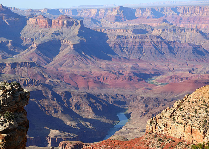 Expansive view of a canyon with steep cliffs and rugged terrain, illustrating dangers that are more severe than they seem.