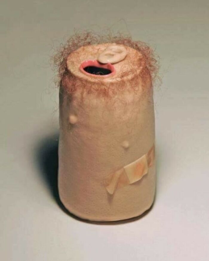 Surreal and confusing sculpture resembling a hairy, bandaged cylinder with facial features, from unhinged weird images collection.