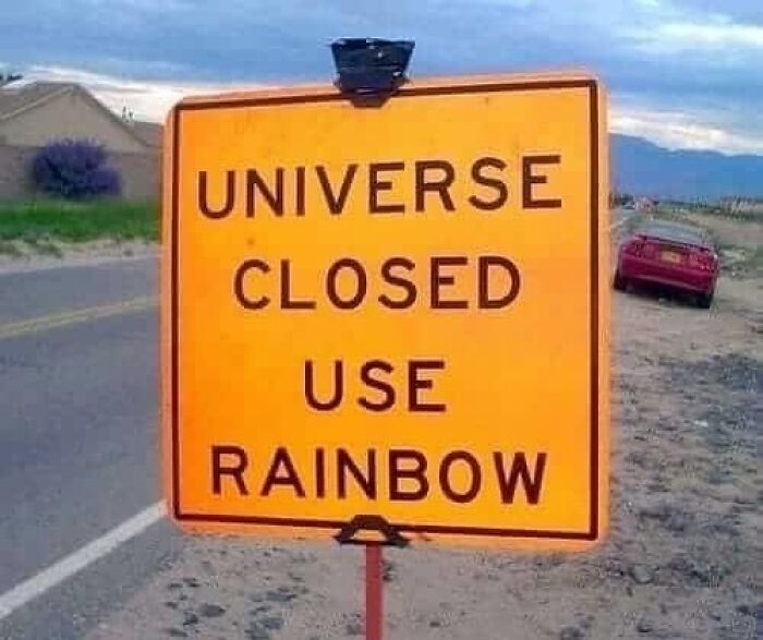 Orange road sign humorously stating universe closed use rainbow, fitting confusing and unhinged images where things get weirder.