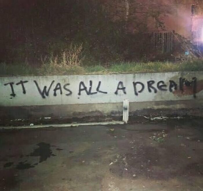 Graffiti on wall reading it was all a dream captured among confusing and unhinged images that get weirder the longer you look.