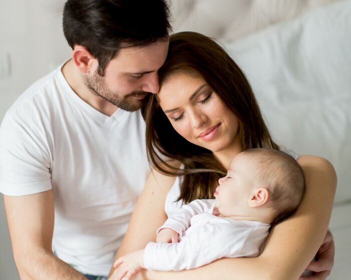 A happy couple with their newborn baby, embodying love and family. They remind us that rumors are a lot to process.