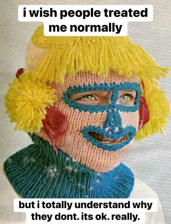 Person wearing a knitted mask with yellow hair and colorful face design, reflecting confusing and unhinged images theme.