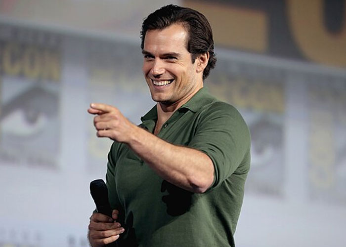 Actor at a public event smiling and pointing, illustrating beloved celebrities and not that nice in real life.