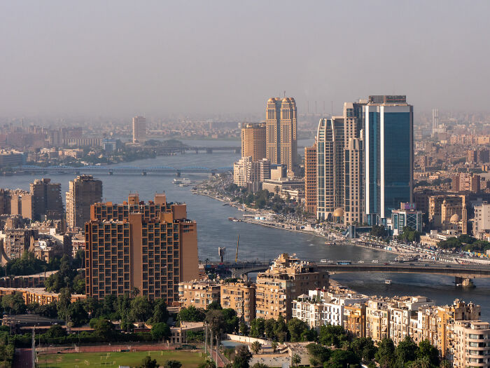 Cairo cityscape with dense buildings, a wide river, and bridges, symbolizing countries with worst work-life balance.
