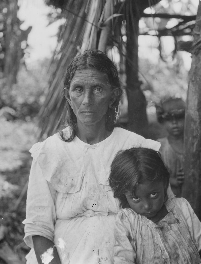 Black and white rare photo of a woman and children from a time we will never experience in real life.