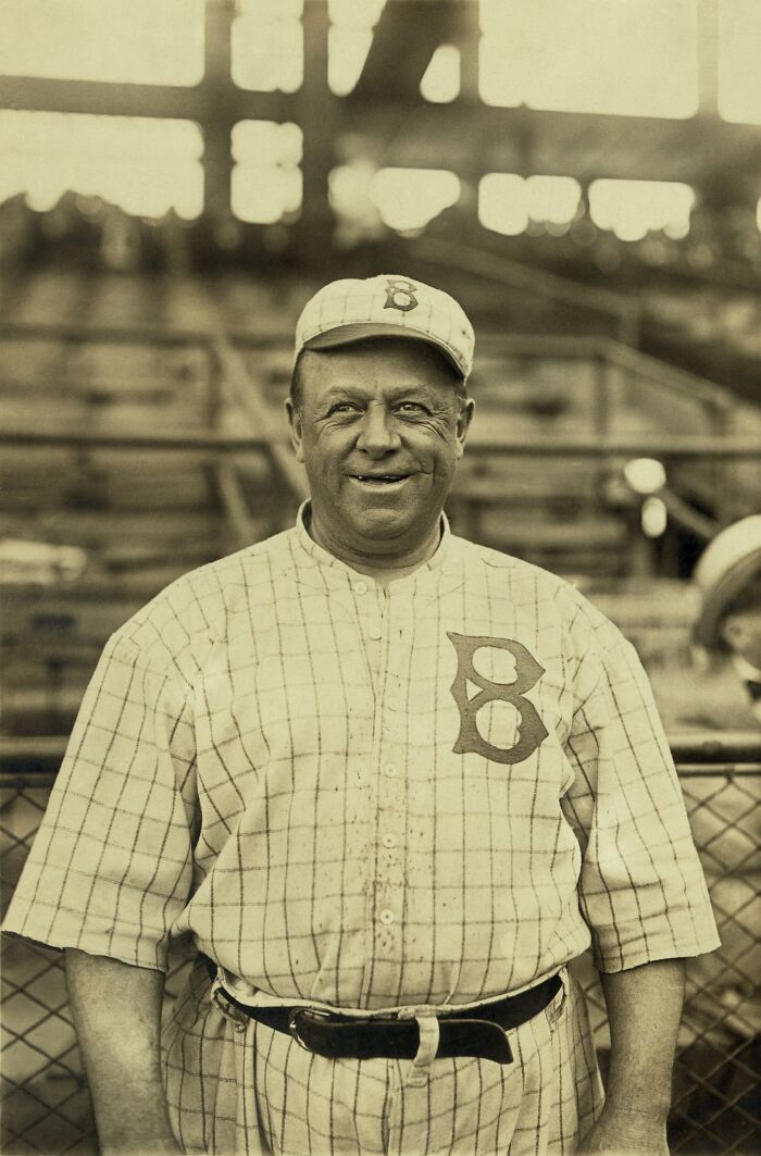 Vintage photo of a smiling baseball player in classic uniform from a rare and interesting time in history.