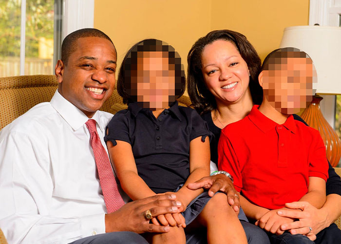 Justin Fairfax with family seated on a couch in a living room, related to holes in her shirt 911 call case.