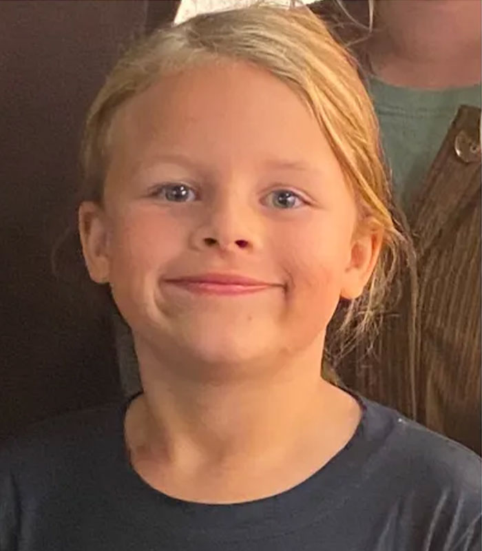 A young girl with blonde hair and blue eyes, smiling slightly, likely Athena Strand, whose life was taken by a FedEx driver.