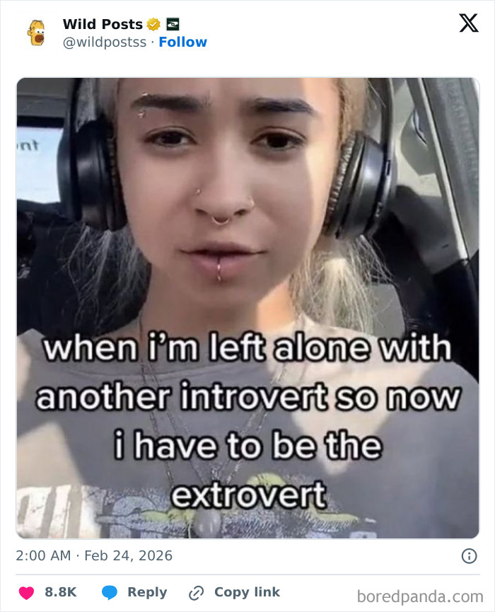 A person wearing headphones and facial piercings, with meme text about being an extrovert among introverts. Wildest posts.
