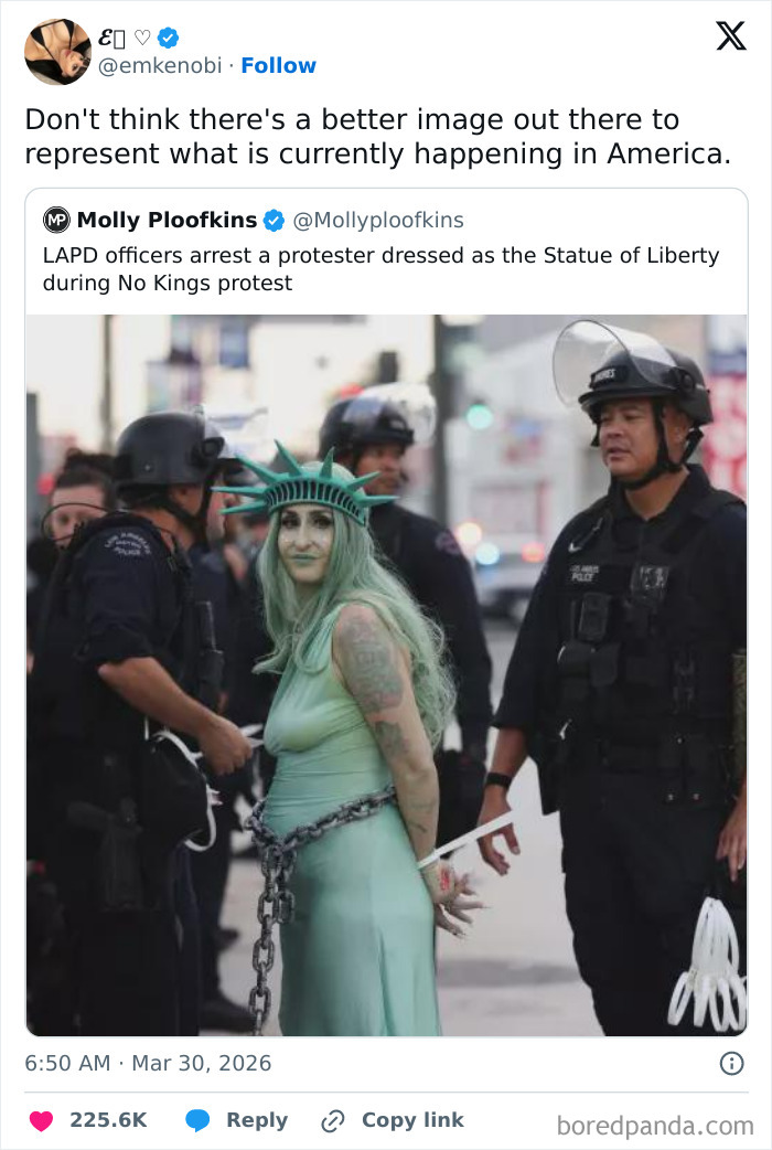 Protester dressed as Statue of Liberty being arrested by police, illustrating a dystopian scene in the United States.