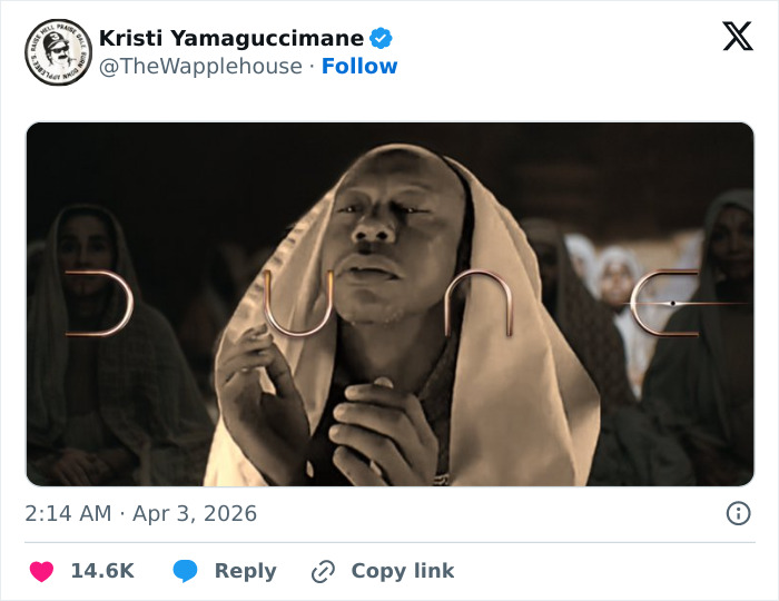 Person wearing a hooded garment with eyes closed, reacting humorously to Tiger Woods arrest footage shared on social media.