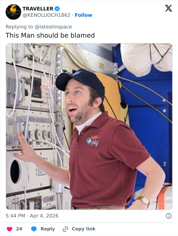 Man in a maroon shirt and cap inside spacecraft, reacting to Artemis II toilet failure and space plumbing issue.