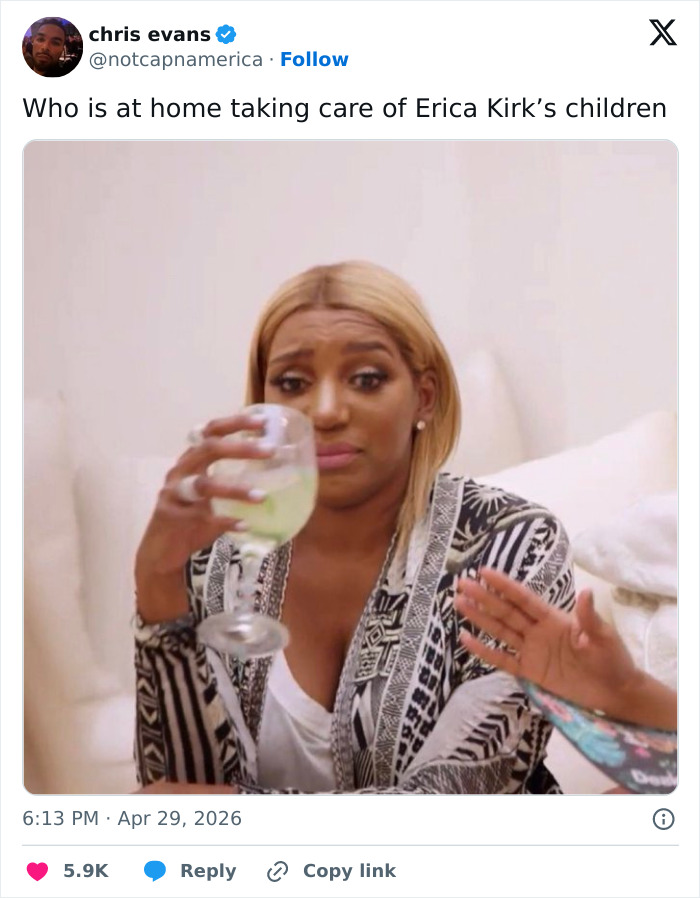 A woman with blonde hair, wearing a patterned kimono and holding a drink, looks concerned. Relates to Erica Kirk's controversial video.