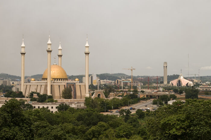 Abuja skyline with the National Mosque and Christian Centre, representing countries with worst work-life balance.