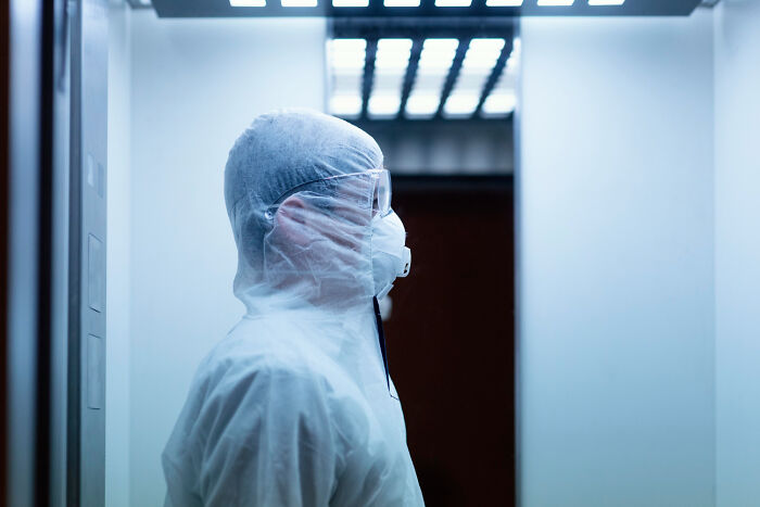 Healthcare worker in full protective gear inside a hospital, highlighting hidden truths of hospital safety and risks.