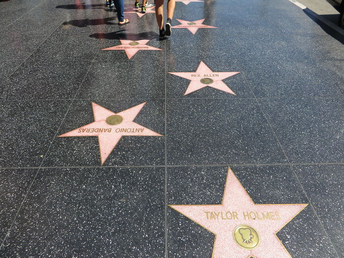 Hollywood Walk of Fame stars on a busy sidewalk, a notable but often crowded US tourist attraction.