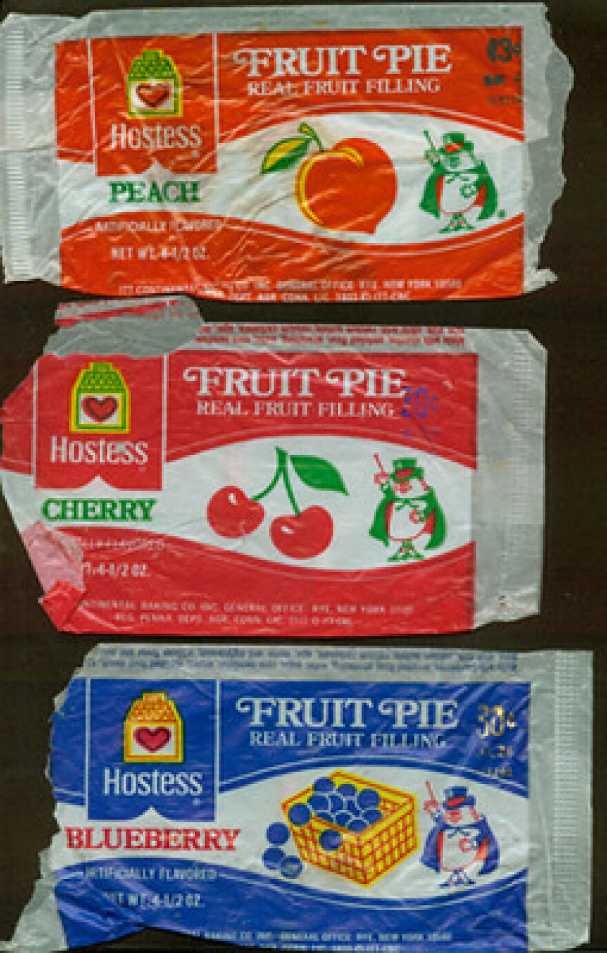 Vintage Hostess Fruit Pie wrappers (Peach, Cherry, Blueberry) evoke a trip down memory lane with classic designs.
