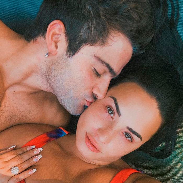 A man kissing a woman on the cheek; she gazes at the camera. This could be 6 years ago, and it sounds unreal today.