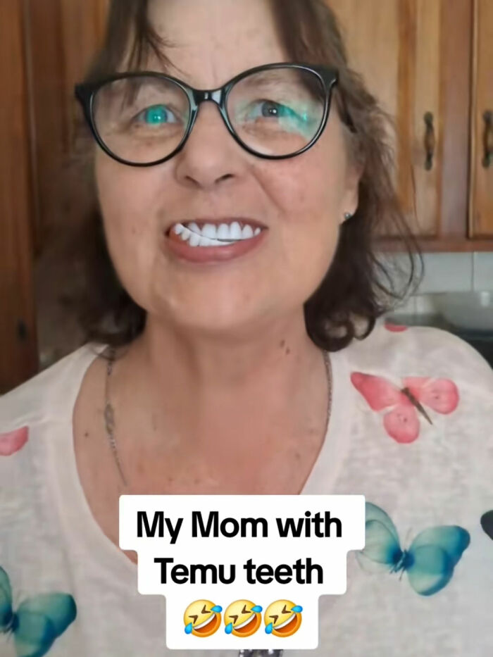 Woman wearing glasses and fake teeth ordered from Temu, showcasing a funny and unexpected product experience in a home setting.