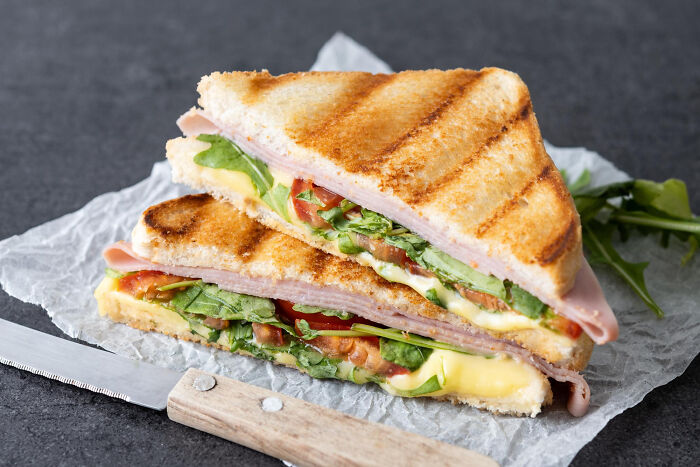 Grilled ham and cheese sandwich with arugula and tomato. A pleasant sight, unlike the nasty things medical workers witnessed.