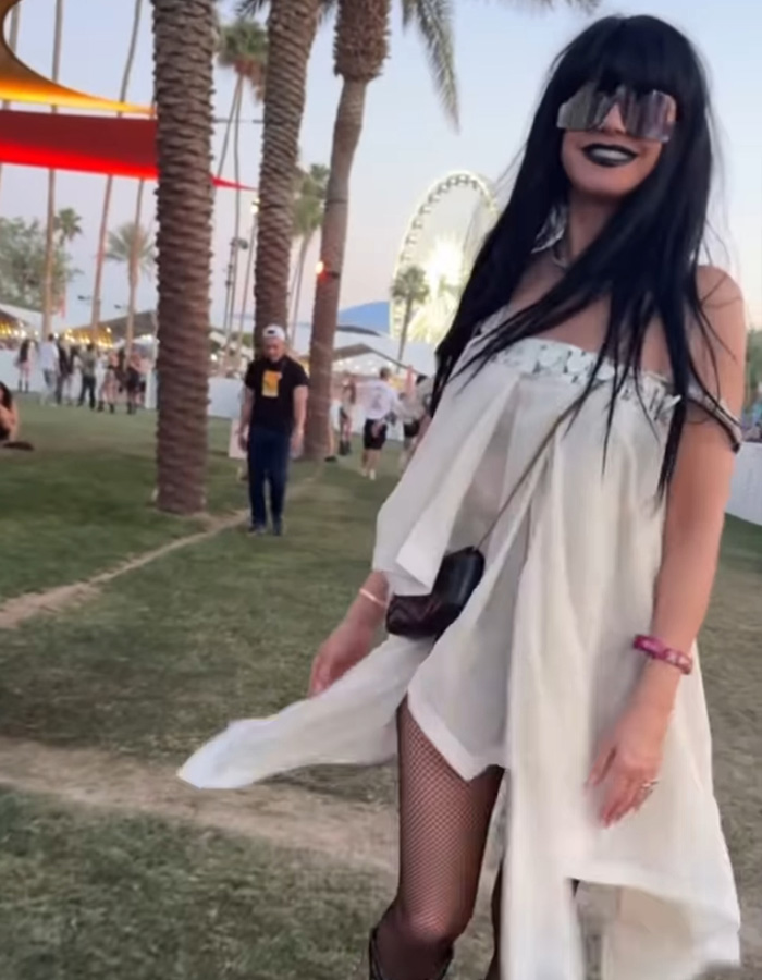 Heidi Klum at Coachella 2026 wearing an unrecognizable outfit with black wig, oversized sunglasses, and fishnet stockings.