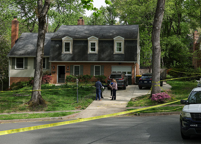 Police tape surrounds a suburban house as investigators discuss the ex-Virginia Lt Governor Justin Fairfax case.