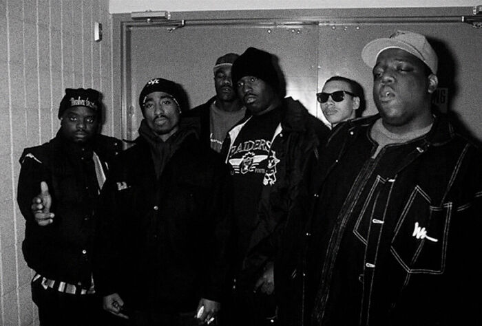 Black and white photo of a hip-hop group from the 1990s, representing cultural moments from the year you were born.