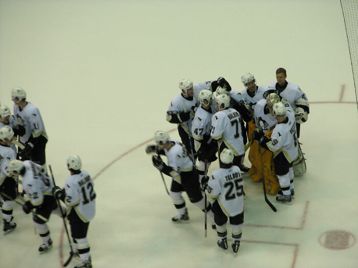 Ice hockey team gathering on the rink after a game, illustrating challenges and common PR mistakes in company communication.