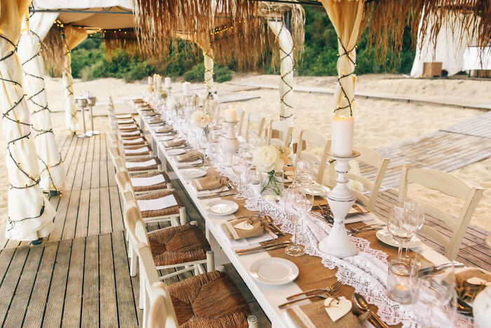 Outdoor wedding reception table setting on beach with elegant decor, capturing moments guests knew would lead to future breakup.