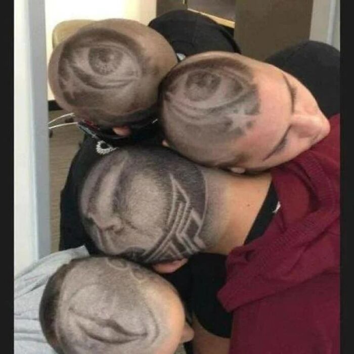 Four people with creative shaved patterns on their heads, including eyes and lips. A weird image.