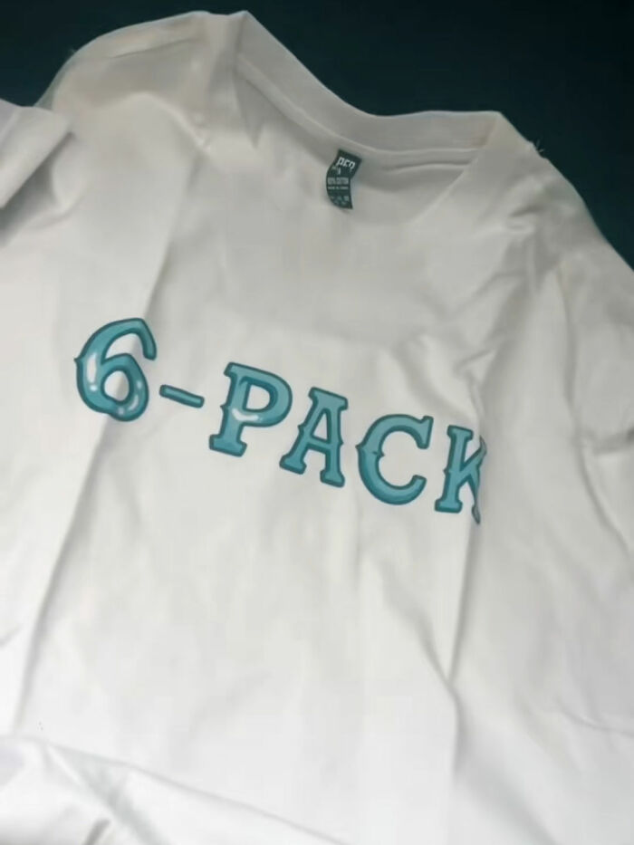 White T-shirt with teal 6-PACK text, an example from people who ordered from Temu and learned a hilarious lesson.