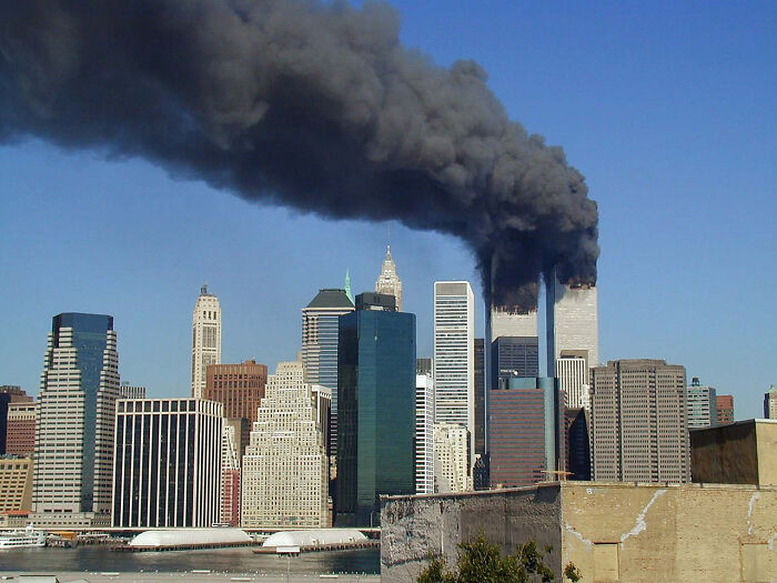 Smoke rising from the Twin Towers in New York City during a major event, highlighting moments in the year you were born.