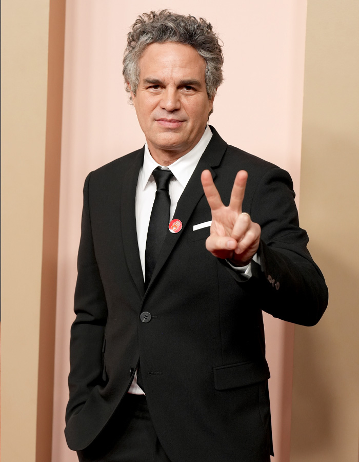 Mark Ruffalo in a black suit gesturing a peace sign, linked to Kate Beckinsale comments on firing and manhood benefits. Mark Ruffalo in a black suit gesturing a peace sign, linked to Kate Beckinsale comments on firing and manhood benefits.