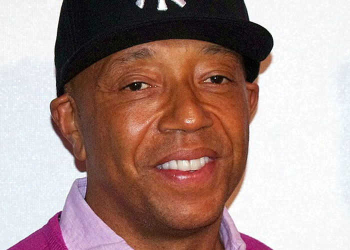 Close-up of a beloved celebrity wearing a black cap and purple shirt, illustrating celebrities not that nice in real life.