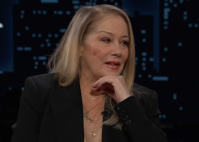 Christina Applegate in a black blazer during an interview, with loved ones concerned by hellish hospitalization details.