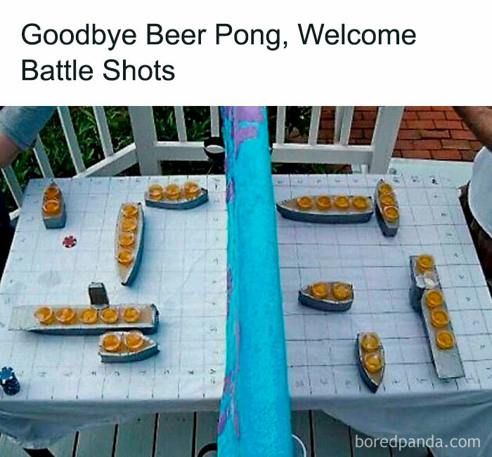 Table set for a wild battle shots game with shot glasses arranged like ships, perfect for unhinged and wild memes amusement.