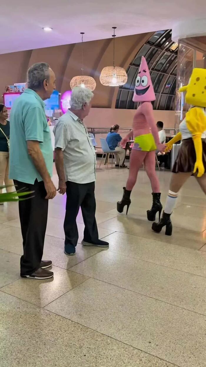 Two men stare at weird images of Patrick Star and Spongebob Squarepants characters in high heels, making people go hmmm.