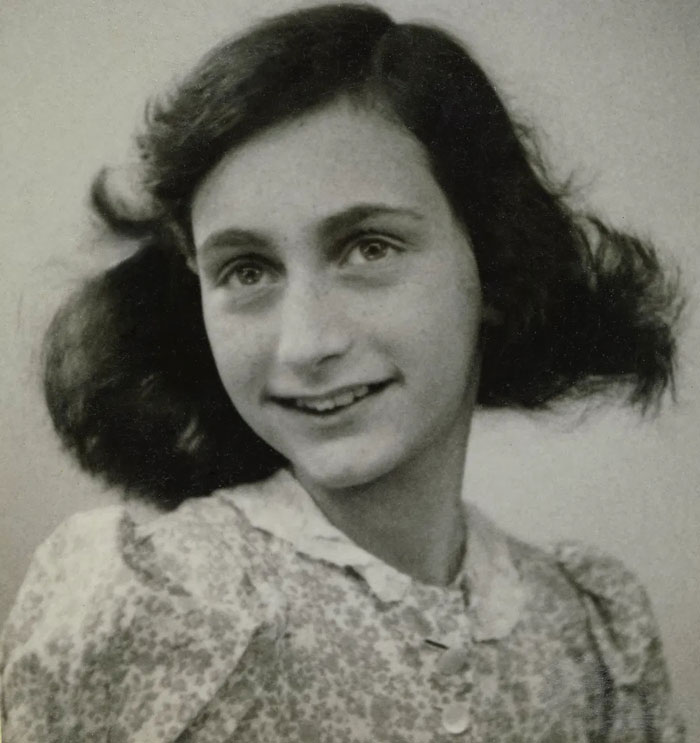 Black and white portrait of a young girl smiling softly, representing one of the massive betrayals in human history.