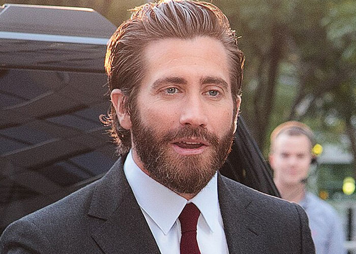 Male beloved celebrity with beard and suit, captured outdoors, illustrating beloved celebrities that are not that nice in real life.