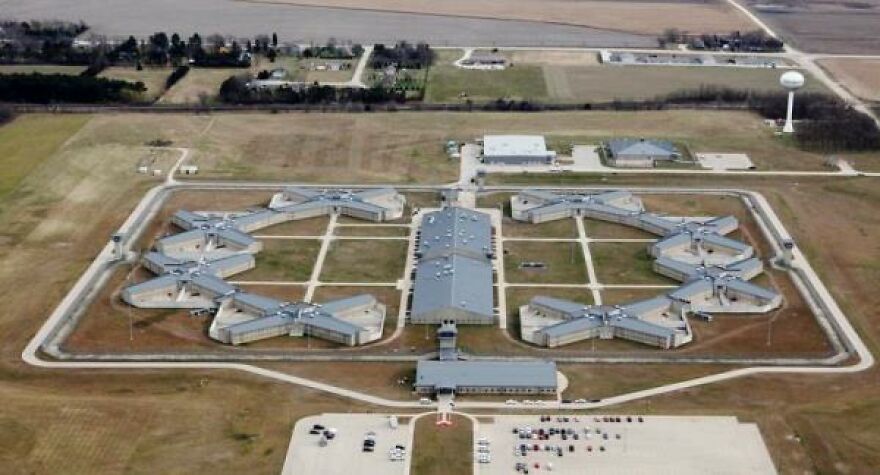 Aerial view of a prison complex, an example of places with toughest security, featuring multiple X-shaped buildings.